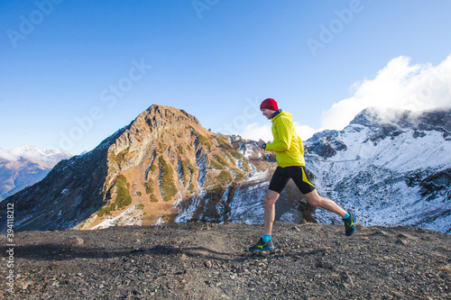 Man running in the mountains. Krasnaya Polyana, Russia