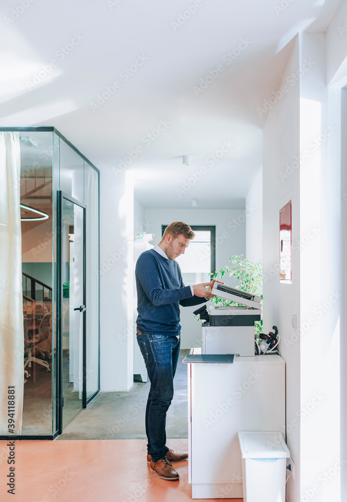 Young Businessman Using Copier Young Businessman Using Copier