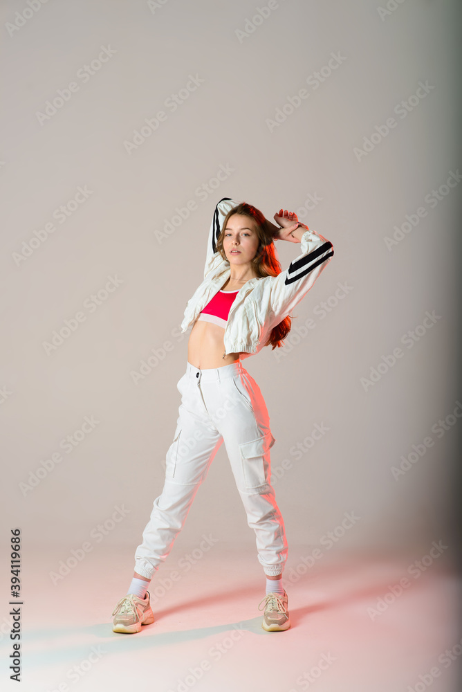Teenage female dancing hip-hop in studio, casual clothes Teenage female dancing hip-hop in studio, casual clothes