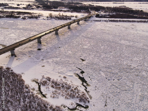 Winter bridge over the Siberian river Tom