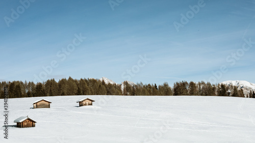 Wooden cottoges in the snow photo