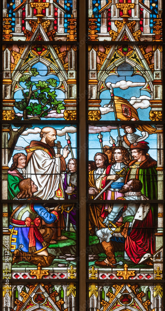 VIENNA, AUSTIRA - OCTOBER 22, 2020:  The papal legate giving the Benedictions to christian nobles on the stained glass in the Laurentiuskirche by workrooms from Czech and Austria (end of 19. cent.).