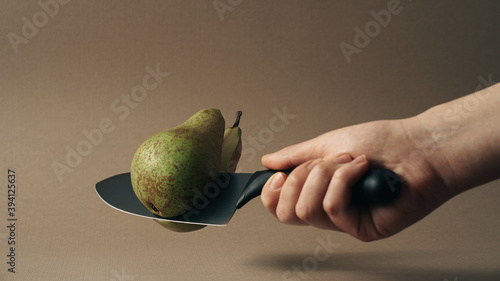 Person Cutting A Pear With Kitchen Knife