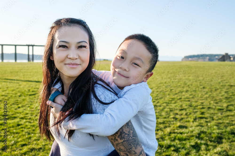 Asian Mother GIving Her Son a Piggyback Ride Asian Mother GIving Her Son a Piggyback Ride