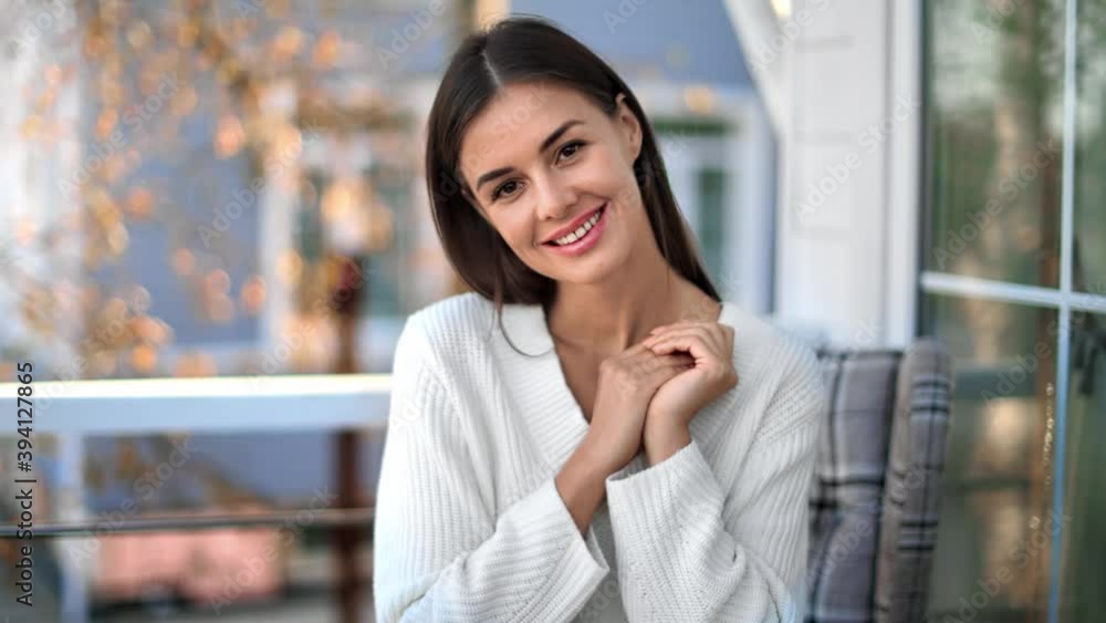 Portrait of cozy beauty female posing at outdoor terrace. Shot on RED Raven 4k Cinema Camera Portrait of cozy beauty female posing at outdoor terrace. Shot on RED Raven 4k Cinema Camera