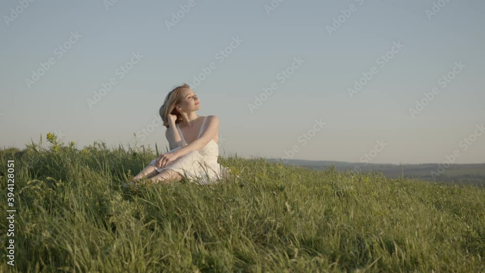young girl in a white dress enjoys life on the meadow young girl in a white dress enjoys life on the meadow