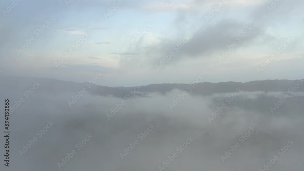 Aerial view starting in the mist and slowly revealing the forest landscape behind the fog
Aerial view starting in the mist and slowly revealing the forest landscape behind the fog