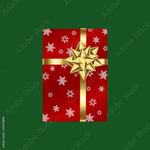 Red gift box with golden ribbon and snowflake pattern