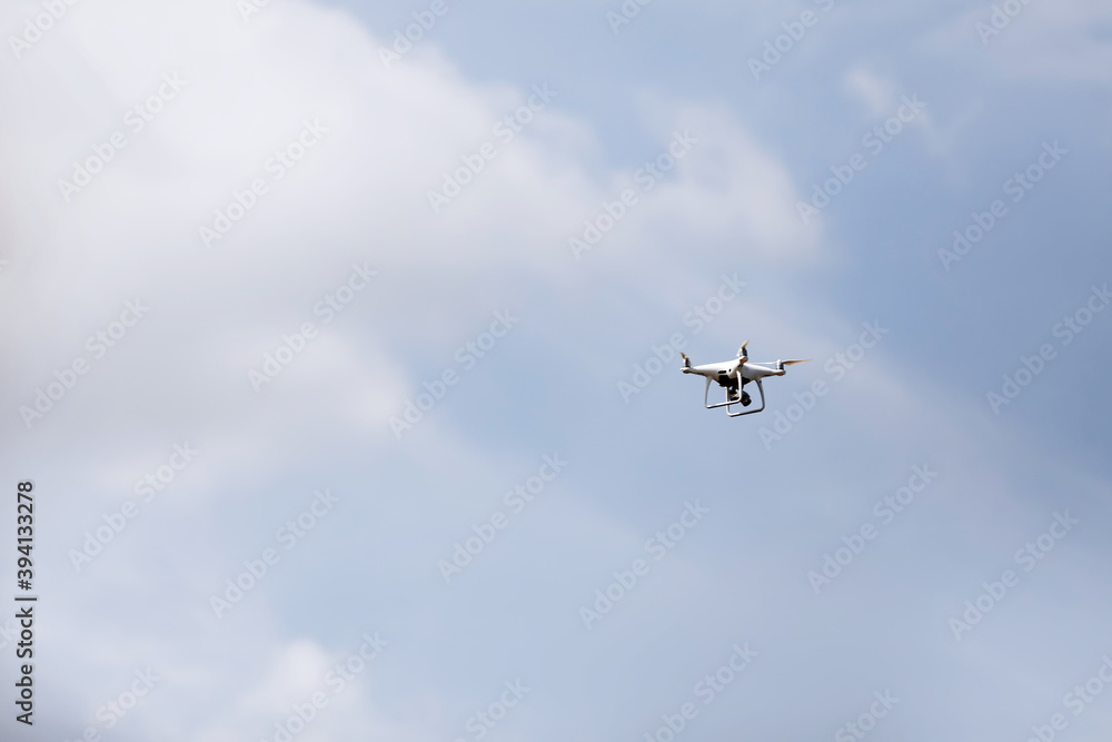 Quadcopter drone in sky. Small drone flies in sky taking video and photos. Remote control air delivery and spy. selective focus. Quadcopter drone in sky. Small drone flies in sky taking video and photos. Remote control air delivery and spy. selective focus.