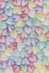 Multicolored paper strips in the shape of hearts on white background