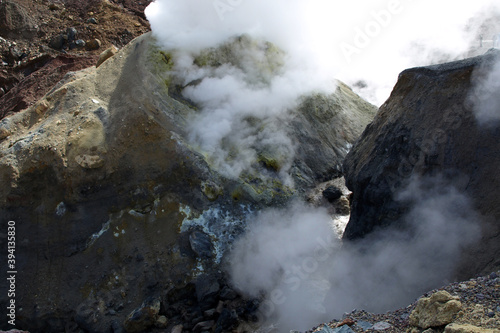 Mutnovsky volcano. Steaming fumaroles on the banks of the mud creek