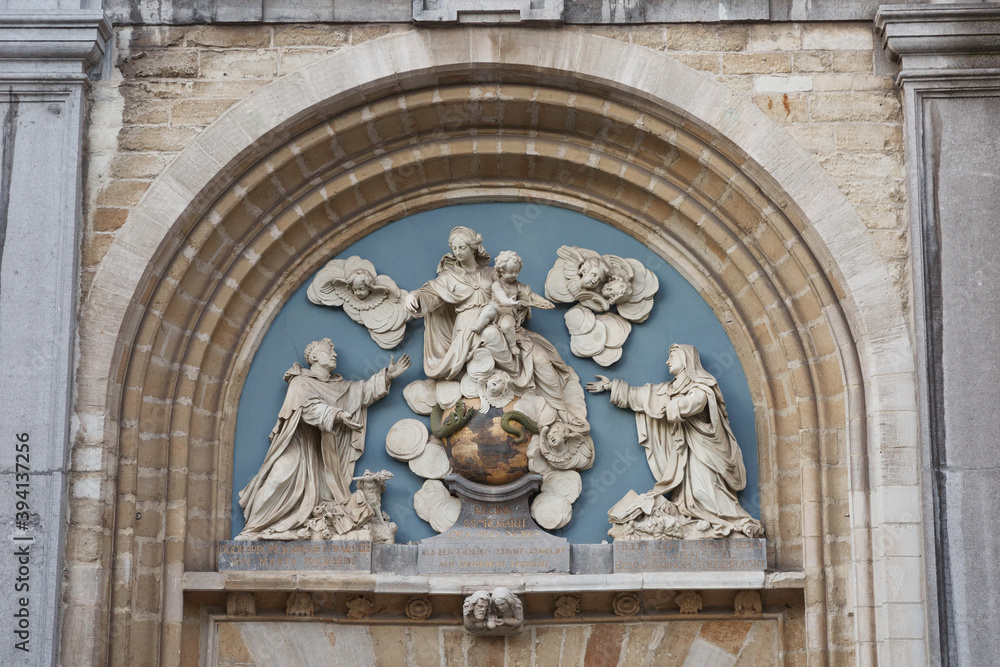 Bas-relief above the entrance gates of the church of St. Paul with the image of the saints. Antwerp. Belgium