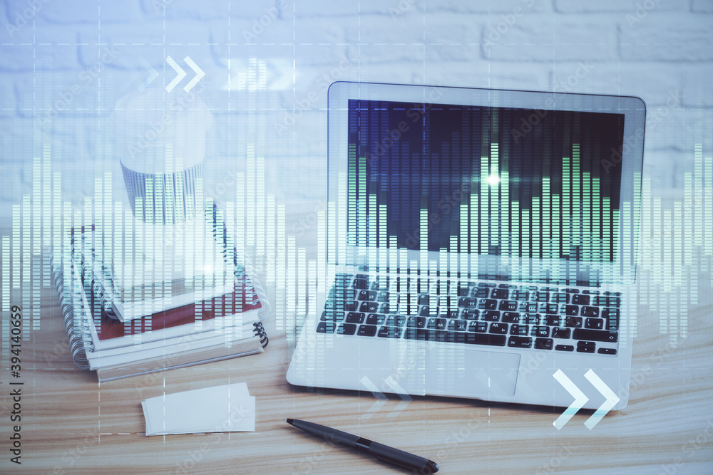 Financial chart drawing and table with computer on background. Double exposure. Concept of international markets. Financial chart drawing and table with computer on background. Double exposure. Concept of international markets.