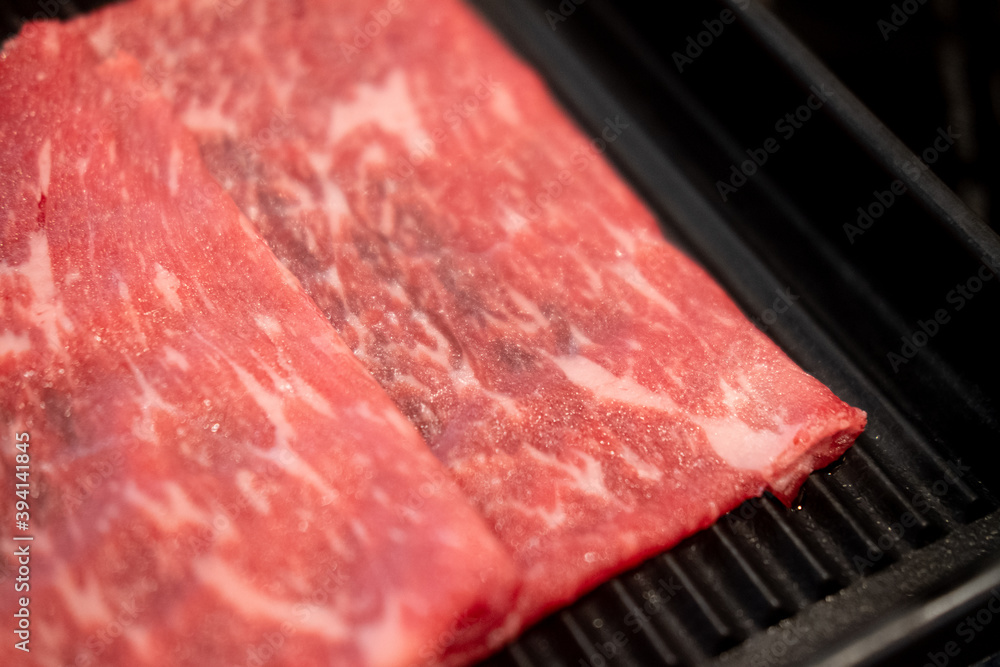 Premium grade of fresh raw thin sliced beef for Shabu Shabu Premium grade of fresh raw thin sliced beef for Shabu Shabu