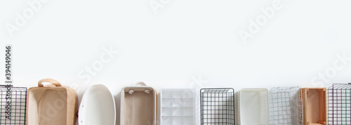 Top view of closet organization boxes and steel wire baskets in different shapes. photo