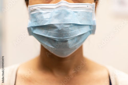 Lady wearing surgical face mask.