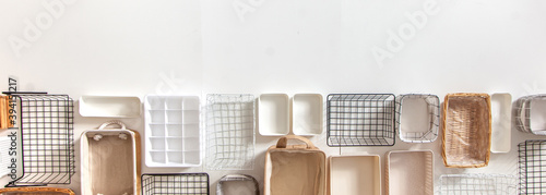 Top view of closet organization boxes and steel wire baskets in different shapes. photo