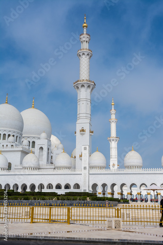 White Minaret of Grand Mosque against blue sky, also called Sheikh Zayed BinSultan Nahyan Mosque, inspired by Persian, Mughal and Moorish mosque architecture, in Abu Dhabi, UAE