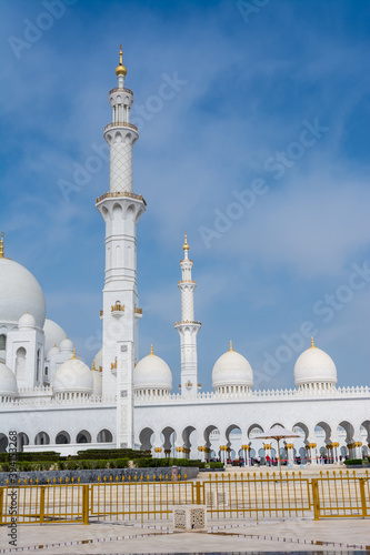 White Minaret of Grand Mosque against blue sky, also called Sheikh Zayed BinSultan Nahyan Mosque, inspired by Persian, Mughal and Moorish mosque architecture, in Abu Dhabi, UAE