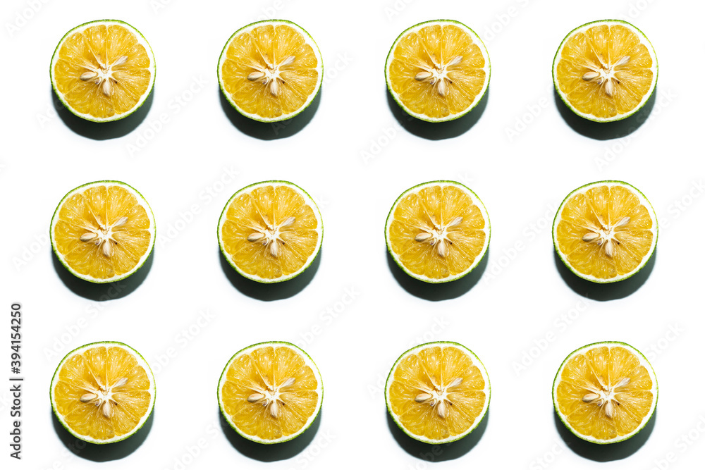 Colorful fruit pattern of fresh mausambi or sweet lemon slices on white background. From top view