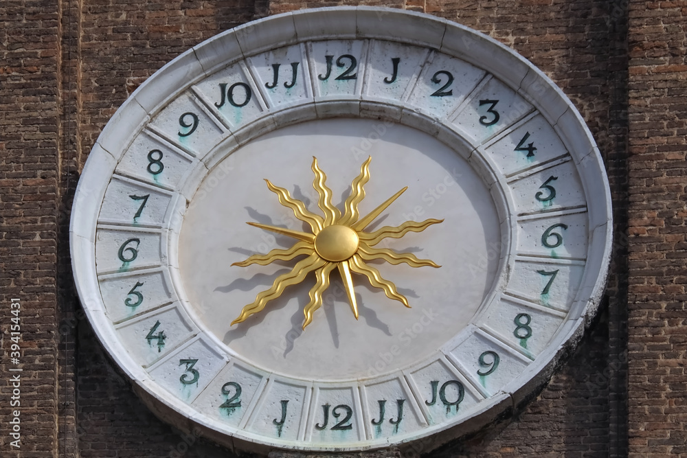 Beautiful sundial with a golden sun in Venice