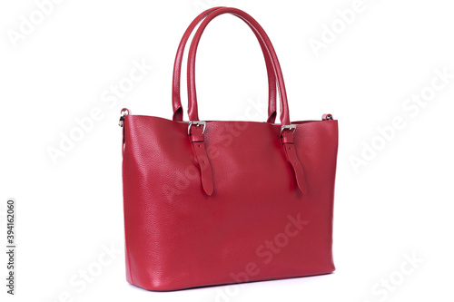 red handbag made of genuine leather close up on a white background