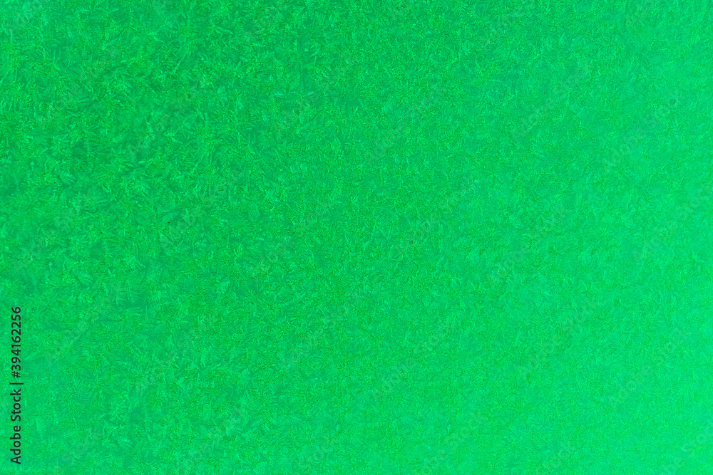 green frost on a glass background. texture patterned frosted glass.
green frost on a glass background. texture patterned frosted glass.