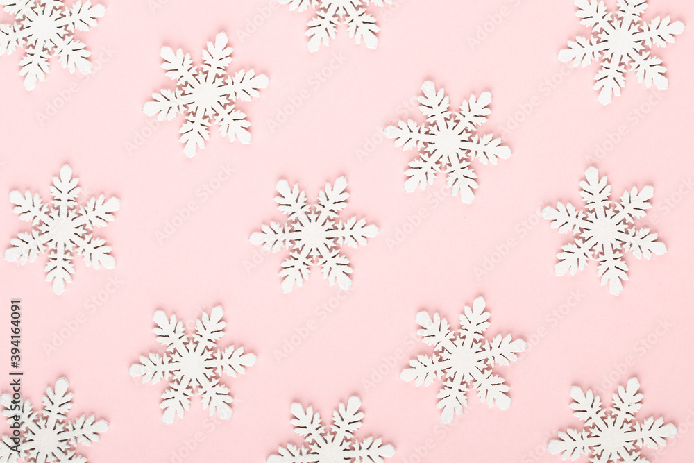 Christmas background. White snow decorations on a pink background. Christmas background. White snow decorations on a pink background.