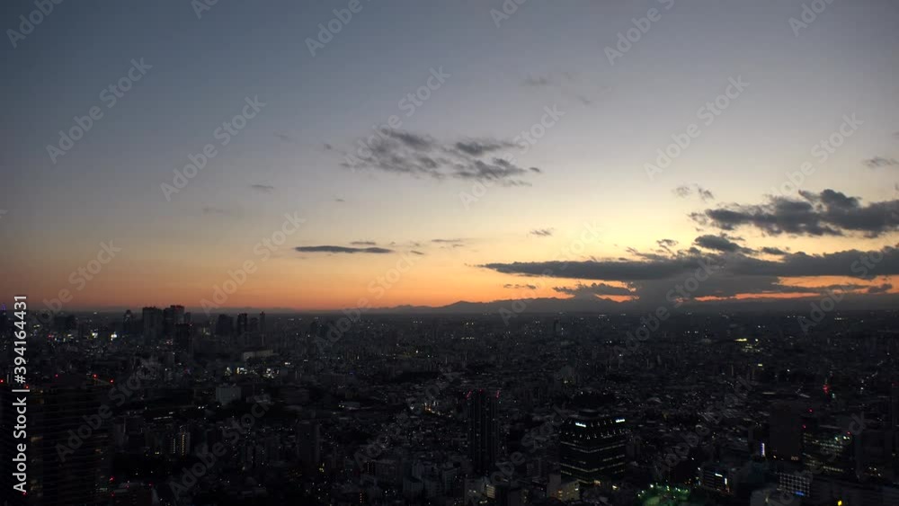 TOKYO, JAPAN : Aerial high angle sunset CITYSCAPE of TOKYO. View of buildings around Shinjuku and Nakano ward. Japanese urban metropolis and nature concept. Long time lapse shot dusk to night. TOKYO, JAPAN : Aerial high angle sunset CITYSCAPE of TOKYO. View of buildings around Shinjuku and Nakano ward. Japanese urban metropolis and nature concept. Long time lapse shot dusk to night.