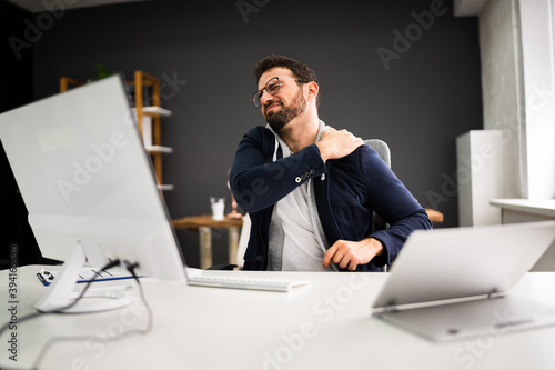 Young Man With Tense Shoulder Pain