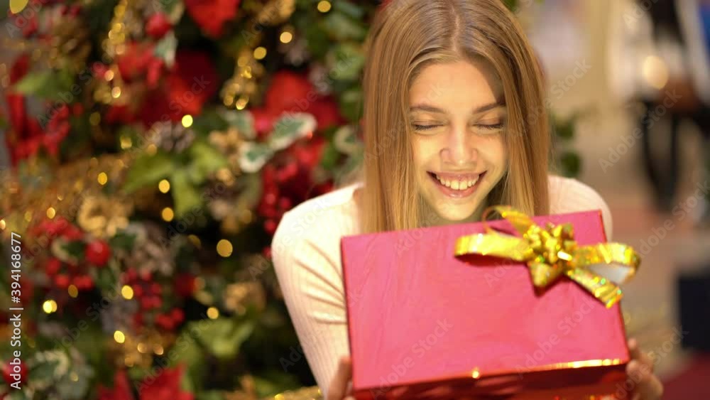 Beautiful girl with a gift on New Year's holiday. Beautiful girl with a gift on New Year's holiday.