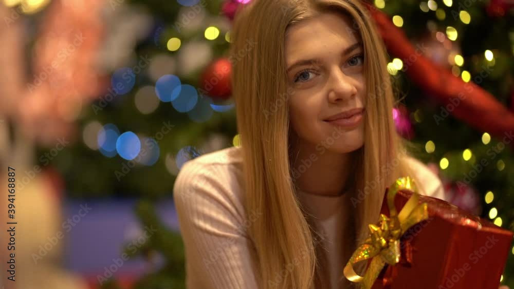 Beautiful girl with a gift on New Year's holiday. Slow motion Beautiful girl with a gift on New Year's holiday. Slow motion