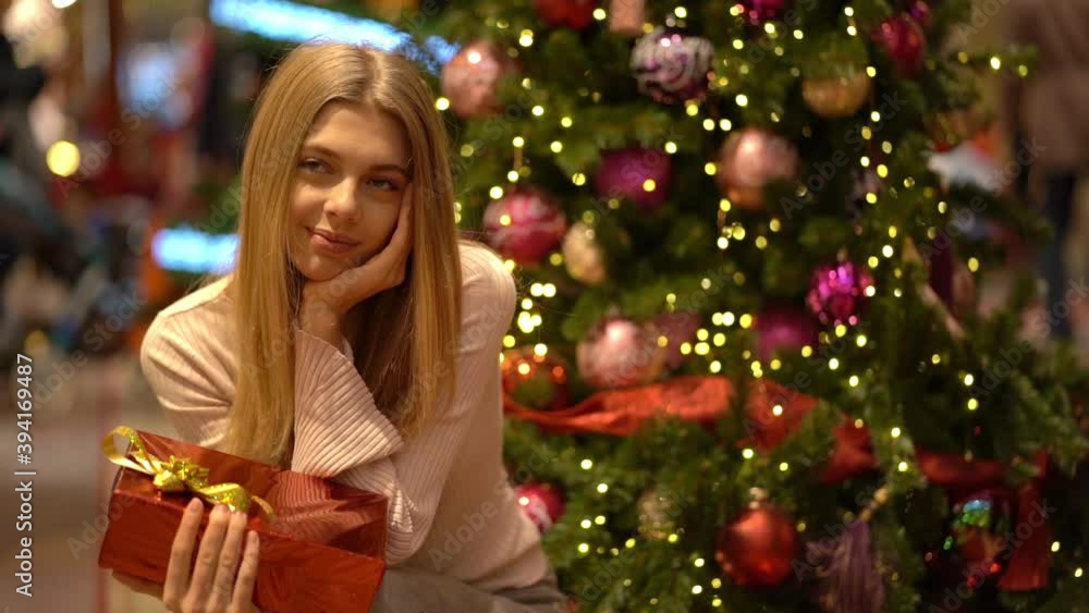 Beautiful girl with a gift on New Year's holiday. Slow motion Beautiful girl with a gift on New Year's holiday. Slow motion