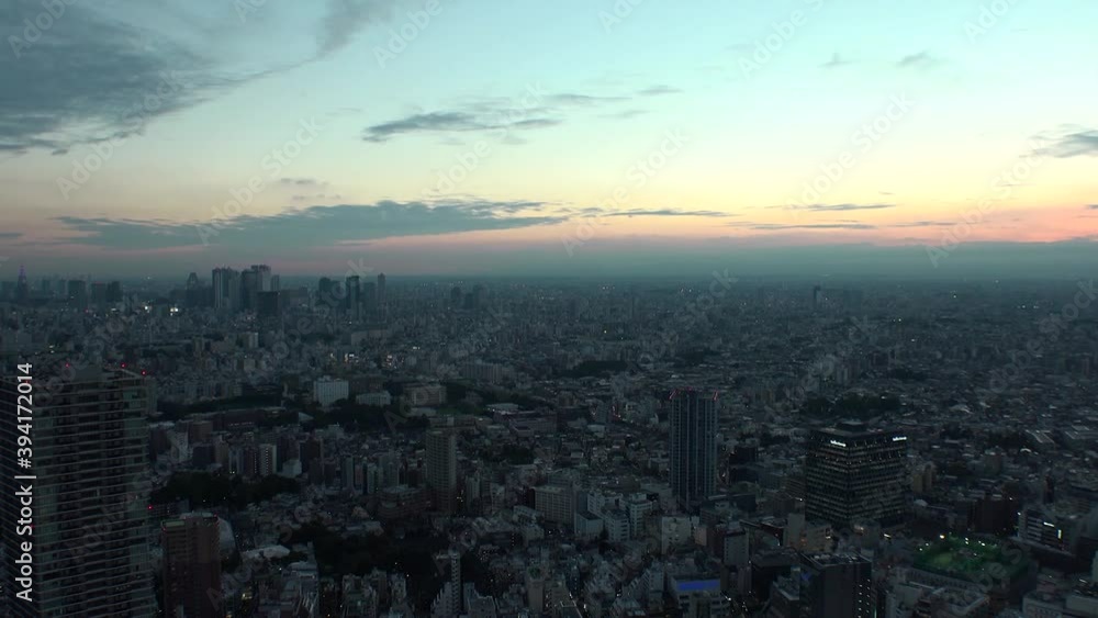 TOKYO, JAPAN : Aerial high angle sunset CITYSCAPE of TOKYO. View of buildings around Shinjuku and Nakano ward. Japanese urban metropolis and nature concept. Time lapse tracking shot dusk to night. TOKYO, JAPAN : Aerial high angle sunset CITYSCAPE of TOKYO. View of buildings around Shinjuku and Nakano ward. Japanese urban metropolis and nature concept. Time lapse tracking shot dusk to night.