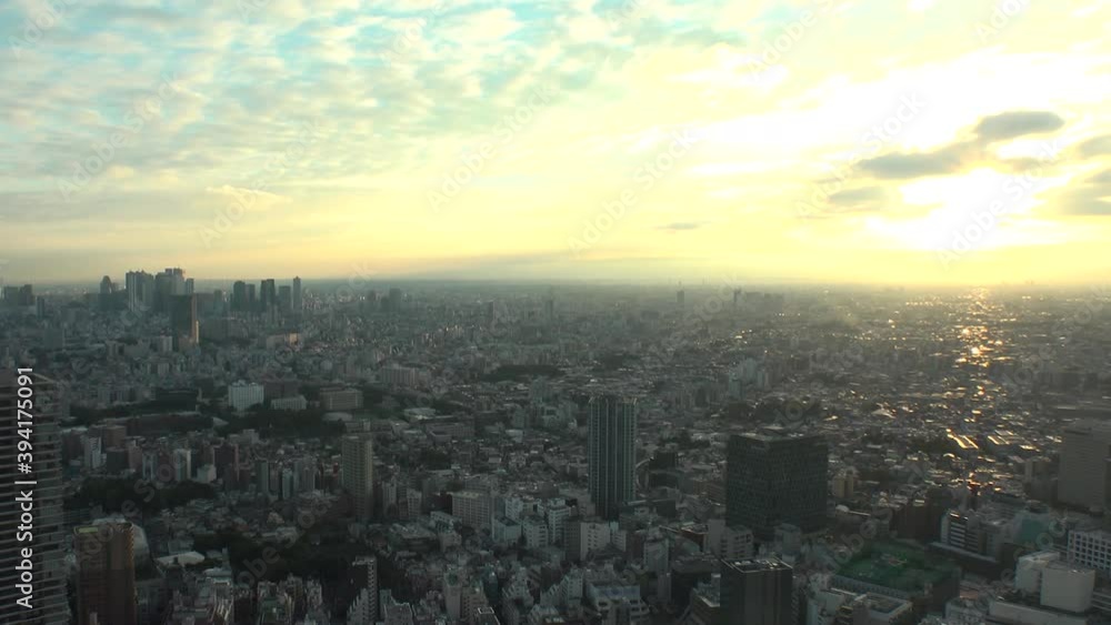 TOKYO, JAPAN : Aerial high angle sunset CITYSCAPE of TOKYO. View of buildings around Shinjuku and Nakano ward. Japanese urban metropolis and nature concept. Time lapse tracking shot dusk to night. TOKYO, JAPAN : Aerial high angle sunset CITYSCAPE of TOKYO. View of buildings around Shinjuku and Nakano ward. Japanese urban metropolis and nature concept. Time lapse tracking shot dusk to night.