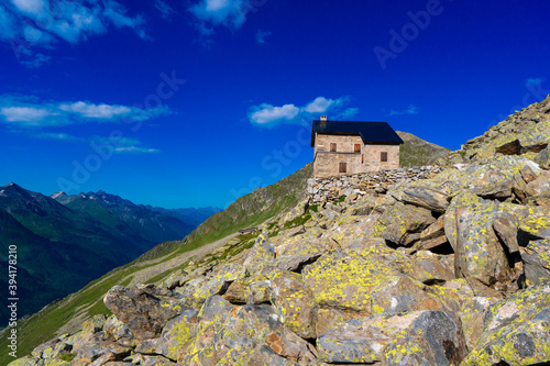 summer sunny day in a mountain valley with hut. Austria Alps.