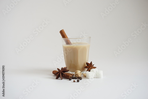 Принти на полотні Autumn drinks concept with front view of masala chai or Indian spices tea on whi