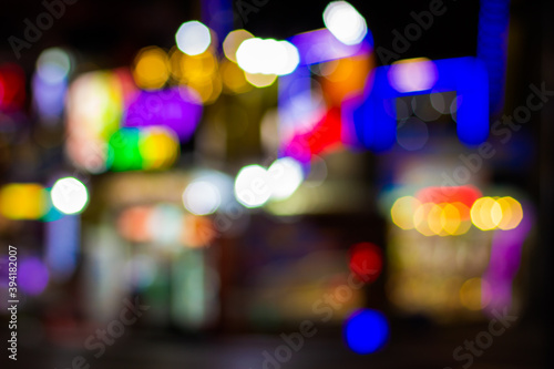 unfocused blurry colorful lights from fair festive garland lamps illumination night street © Артём Князь