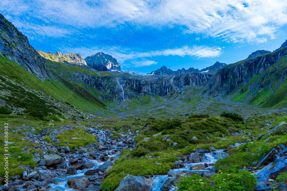 Summer view of alpine mountain valley with winding stream near Zillergrundl. Austria Zillertaler Alpen tirol.