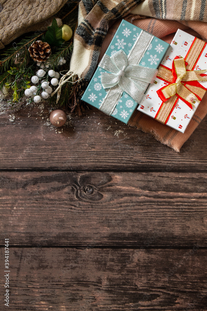 Christmas concept. Christmas presents gift red box and blue box tree branch decor on a wooden table. Top view flat lay background. Christmas concept. Christmas presents gift red box and blue box tree branch decor on a wooden table. Top view flat lay background.