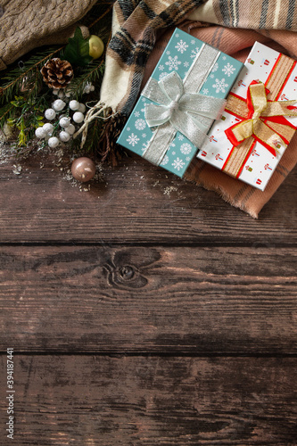 Christmas concept. Christmas presents gift red box and blue box tree branch decor on a wooden table. Top view flat lay background.