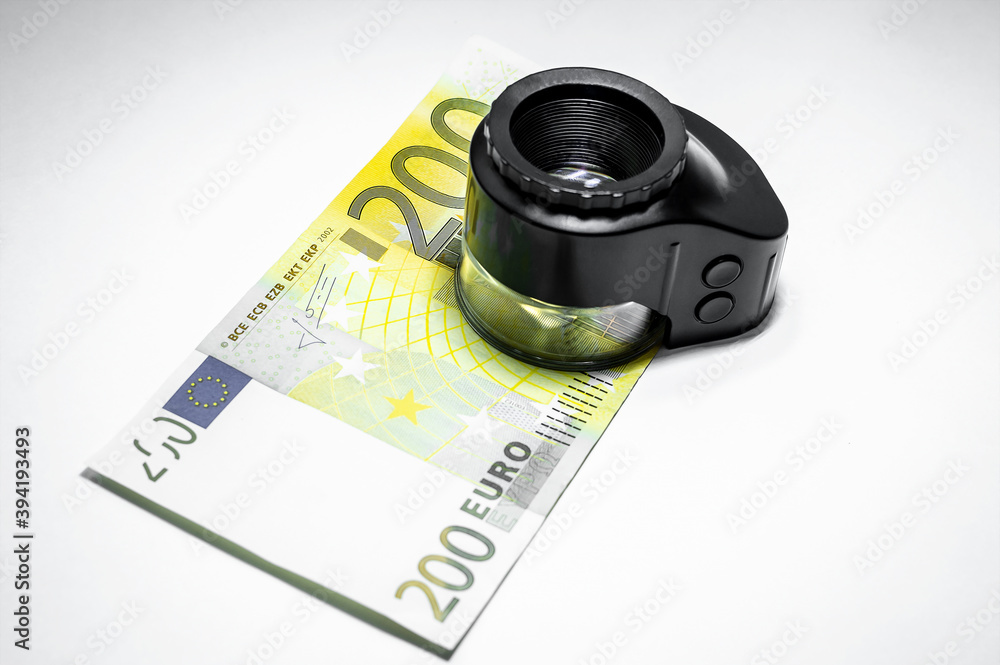 Two hundred euro banknote and loupe or Magnifier for authentication on a white isolated background. Concept - checking money for authenticity. Stock market analysis 3D illustration.