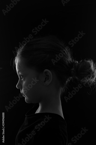 Vászonkép chiaroscuro portrait of a cute little girl