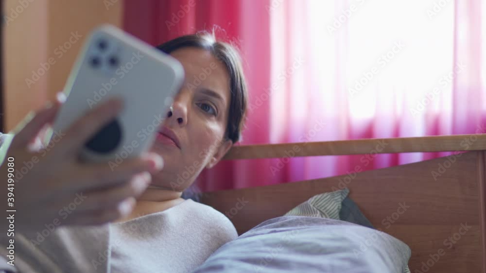 Beautiful woman on the bed talking on mobile phone. High quality 4k footage Beautiful woman on the bed talking on mobile phone. High quality 4k footage