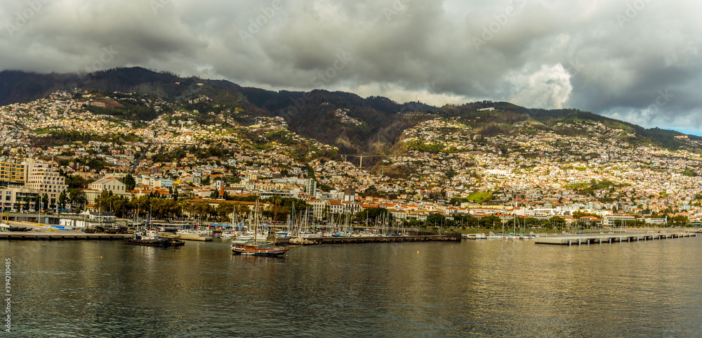 The city of Funchal and harbour in Madeira basking in the early evening sunshine
