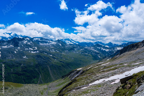 Landscape mountain view peaks in snow and green hills, deep blue sky and huge white clouds background, Hohe Tauern Austrian Alps, Europe © Martin