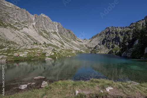 On the shore of Cap de Port lake, after the descent from from Port de Rius mountain pass, on trail GR11.18 to Restanca refuge, Aiguestortes & Estany de Sant Maurici National Park, Pyrenees, Spain.