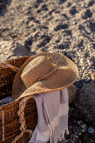 Summer concept. Woven basket with a straw hat and picnic blanket