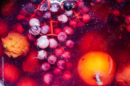 Stewed apples, grapes and plums are cooked in a pan