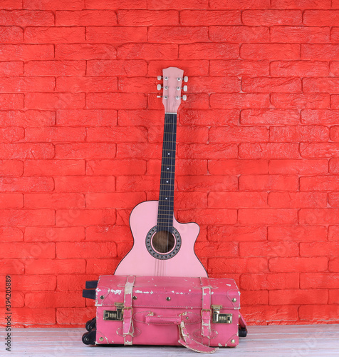 pink guitar and vintage pink travel suitcase © serikbaib